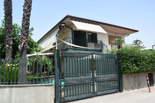 a green gate in front of a house at Blue Coast Sicily in Fondachello