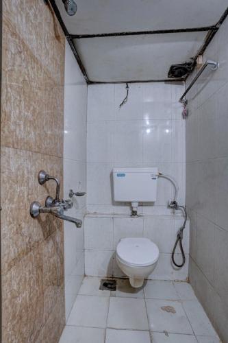 a bathroom with a white toilet in a room at Hotel Saini,Mumbai in Mumbai