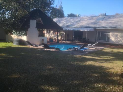 a house with a swimming pool in the yard at 15 On Reitz Bela bela in Bela-Bela