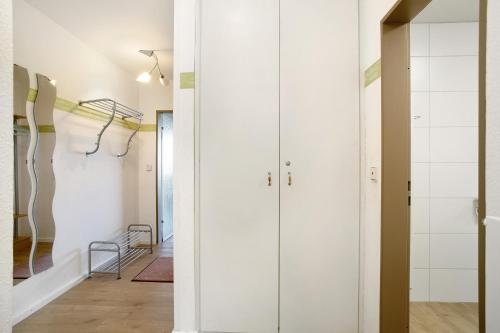 a hallway with white walls and glass doors at Wanderglück in Missen-Wilhams