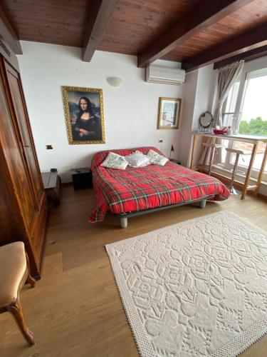 a bedroom with a bed and a rug at San Marino Skyline - Dante in Valdragone