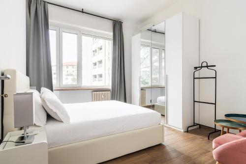 Habitación blanca con cama y ventana en Sabotino apartment, en Milán