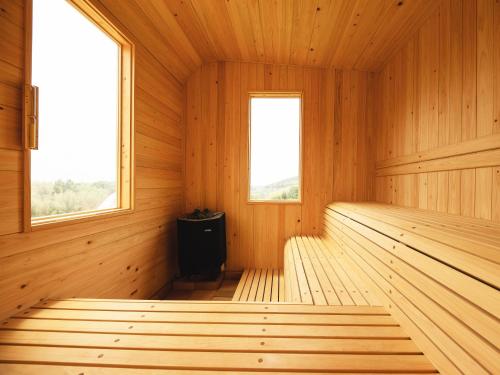an empty wooden sauna with two windows at Hole 37 in Tsukuba