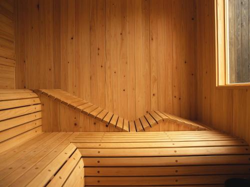 an empty wooden sauna with a window in it at Hole 37 in Tsukuba