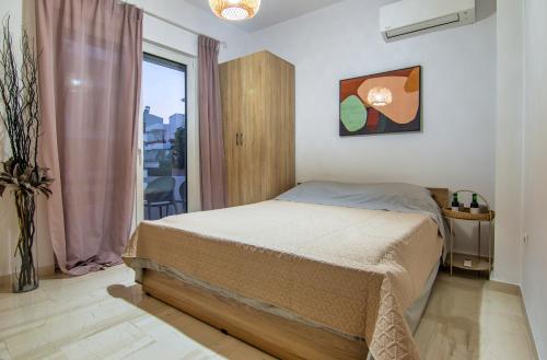 a bedroom with a bed and a window at Anali Apartment in Ixia