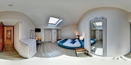 a large room with a bed and a mirror at Hôtel du Parc in Lyon