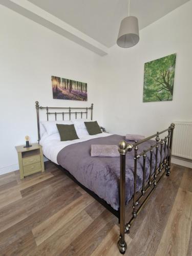 1 dormitorio con 1 cama y suelo de madera en Direct Booking Prices, Studio Apartment, Free Parking, Wifi, Central, Quiet, en Exeter