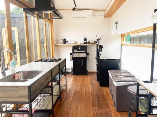 a kitchen with a sink and a stove at Hole 37 in Tsukuba