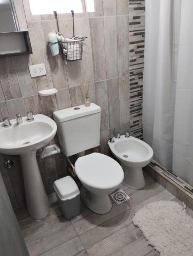 a bathroom with a toilet and a sink at El RANCHO in San Martín