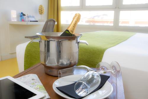 a bottle of champagne in a bucket on a table at Casual del Mar Málaga in Málaga