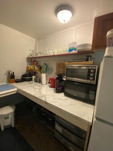 a kitchen with a counter top with a microwave at Ingonish Loft in Ingonish