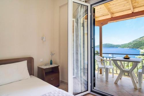a bedroom with a bed and a view of the ocean at Vardia studio A in Mikros Gialos
