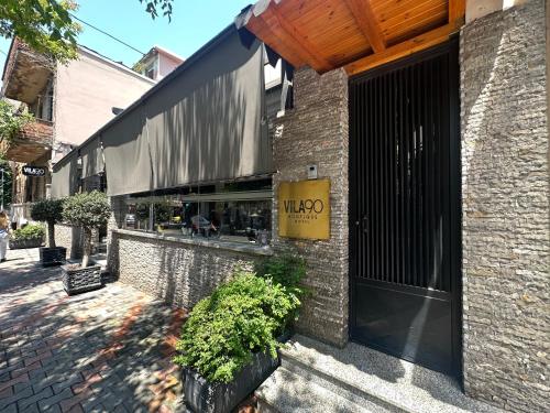 a store with a sign on the side of a building at Vila 90 Boutique Hotel in Tirana