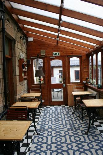 an empty restaurant with wooden tables and benches at Argyle Backpackers in Edinburgh