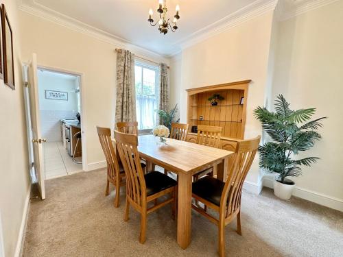 a dining room with a wooden table and chairs at 59 Moss Green - Close to the city centre in York