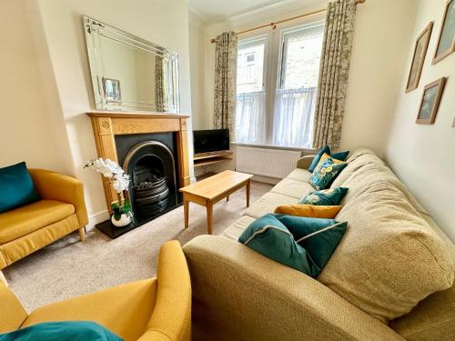 a living room with a couch and a fireplace at 59 Moss Green - Close to the city centre in York