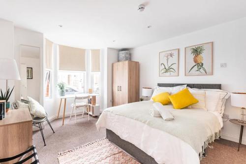 a bedroom with a large bed with yellow pillows at Northumberland Boutique Guest House #1 in Coventry