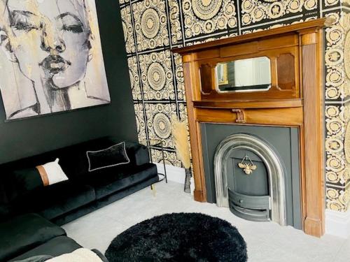 a living room with a fireplace and a tv at Paradise Street Apartment 2 Bed Ground Floor in Rhyl