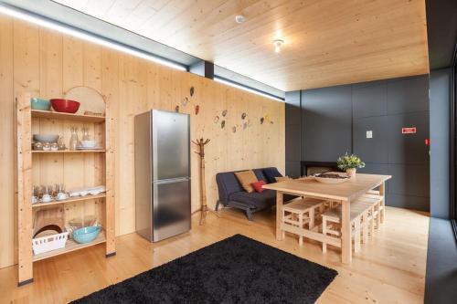 a kitchen and dining room with a refrigerator and a table at Quartéis de Santa Justa in Cerquido