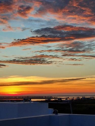 a view of a sunset from the roof of a building at Miss Travel Homestay in Huxi