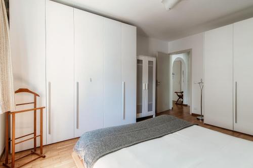a bedroom with white cabinets and a bed at Victoria Apartment by Quokka 360 - simple and practical flat in Locarno in Solduno
