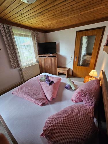 a bedroom with a bed with two stuffed animals on it at Henry‘s sweet home in Neukirchen am Großvenediger