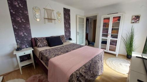 a bedroom with a bed with a pink blanket at Apartment Amarone, 4th floor, no elevator in Zagreb