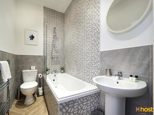 a bathroom with a sink and a tub and a toilet at Host Liverpool - Smithdown Hub, Shops & Eats, by centre in Liverpool