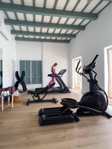 a fitness room with treadmills and exercise bikes at Cristine Bedfor Mahon in Mahón