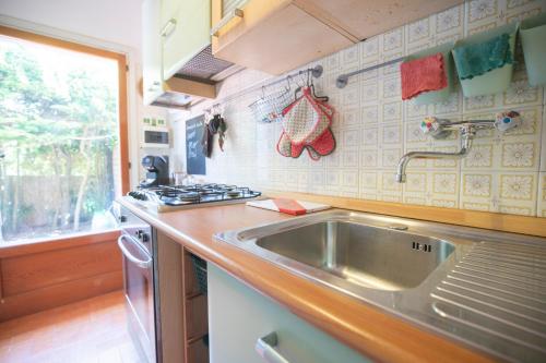 a kitchen with a sink and a stove at Villetta Schiopparello by HelloElba in Portoferraio