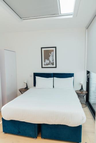 a bedroom with a large bed in a room at Access Brick Lane in London