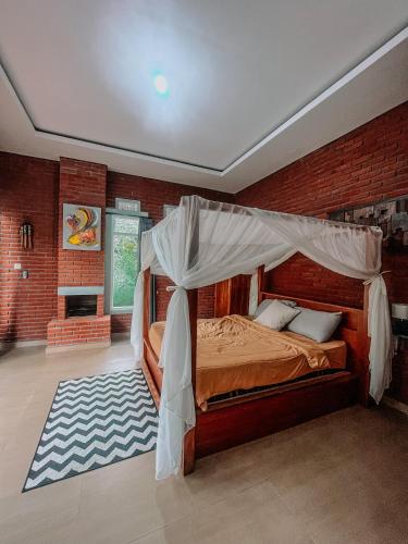 a bedroom with a bed with a canopy at Kubu Kawi in Munduk