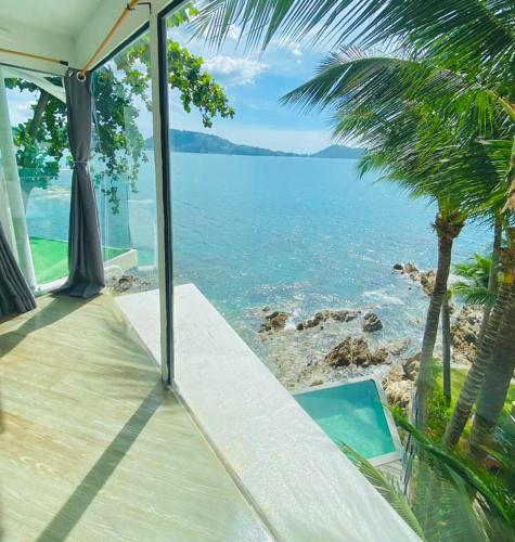 a house with a view of the ocean at patong sunset villa Phuket in Patong Beach
