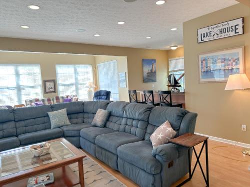 a living room with a blue couch and a table at 5 Bedroom Home in Old Homestead II in Huron