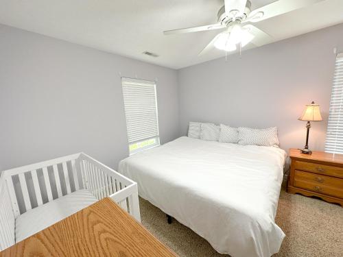 a bedroom with a bed and a ceiling fan at 5 Bedroom Home in Old Homestead II in Huron