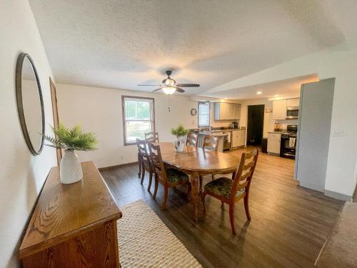 a kitchen and dining room with a table and chairs at Rye Beach Family Cottage in Huron