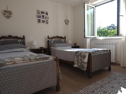 1 dormitorio con 2 camas y ventana en Casa vacanze Lepa Vida en Sistiana