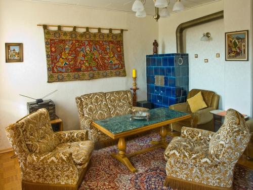 a living room with chairs and a table and a rug at Freyja in Beerfelden