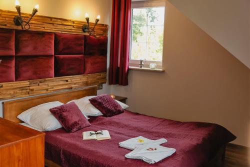 a bedroom with a bed with two towels on it at Willa Kazimiera in Kazimierz Dolny