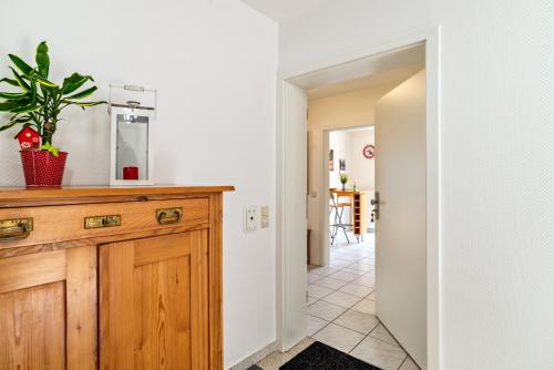 a kitchen with a wooden cabinet and a mirror at Ferienwohnung Liebich in Bühl