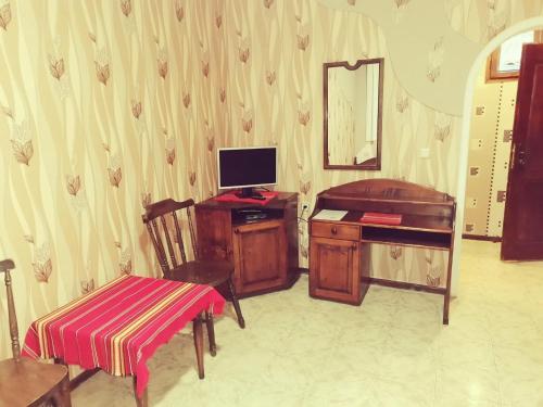 a room with a desk with a computer and a chair at Хотел механа Караджейката 