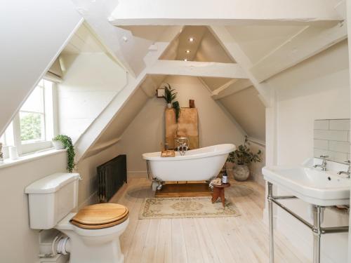 uma casa de banho com uma banheira branca e um lavatório. em Reybridge House em Chippenham