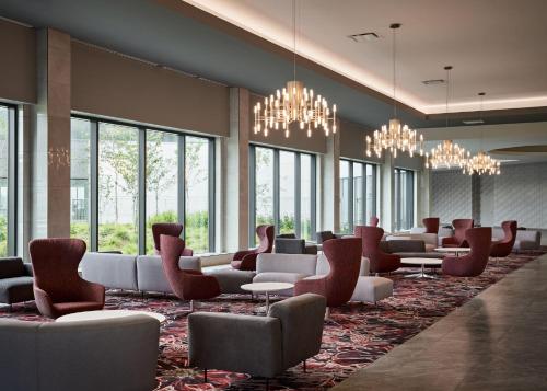 a waiting room with couches and chairs and windows at Great Canadian Casino Resort Toronto in Toronto