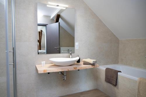 a bathroom with a sink and a mirror at Hotel Preyt -Self Check In- in Holtlander Nücke