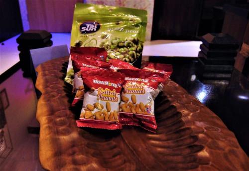 a table topped with bags of potato chips and other snacks at Boutique Studio- Riverine Diamond in Kuching