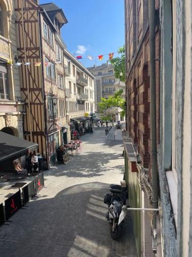 a motorcycle parked on a street next to a building at Studio au cœur de Rouen in Rouen