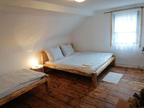 a bedroom with two beds and a window at Brána do Českého Švýcarska - ráj cyklostezek in Staré Křečany