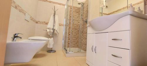 a white bathroom with a sink and a shower at Antico Principato di Seborga in Vallebona