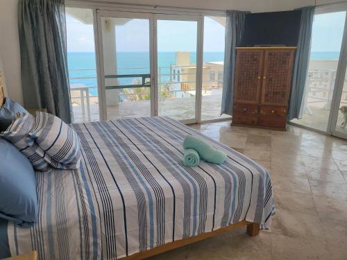 a bedroom with a bed with a blue toy on it at Hotel Luz de Mar ' right on the beach in Cuatunalco