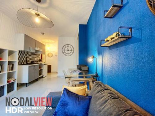 - un salon avec un mur bleu et un canapé dans l'établissement Le Libé 207 - Nice centre - Libération, à Nice